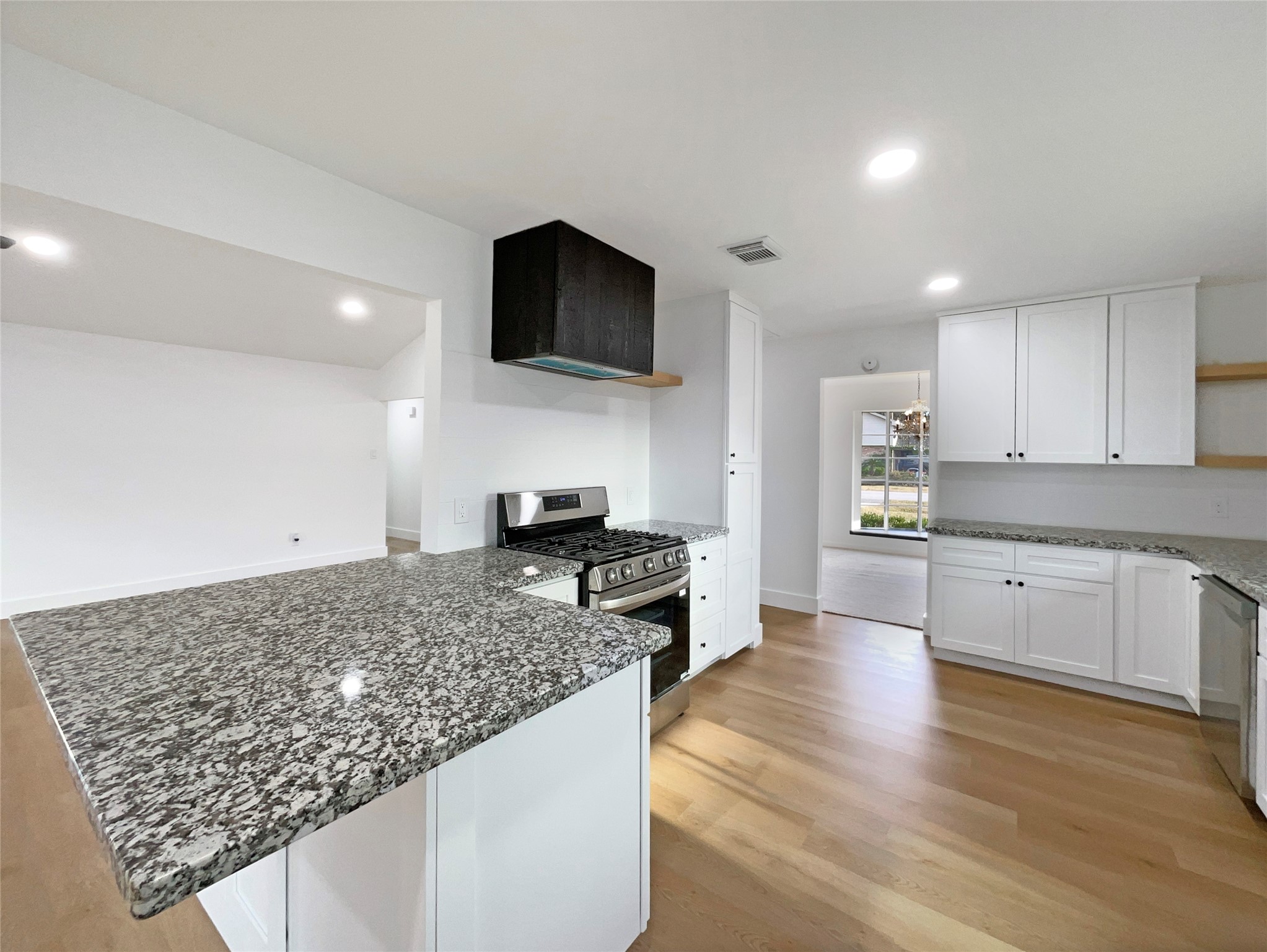 3302 Windsor Drive Pearland, TX 77581 - Photo 12 of 21 a kitchen with stainless steel appliances kitchen island granite countertop a stove and a sink