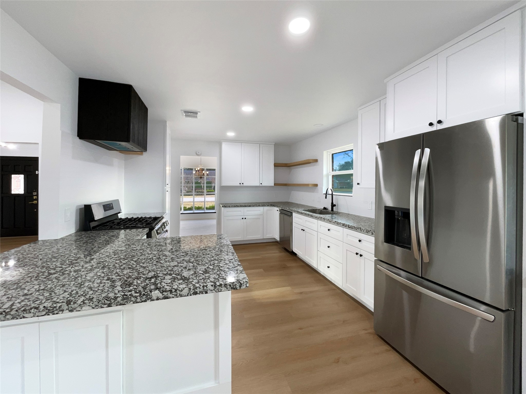 3302 Windsor Drive Pearland, TX 77581 - Photo 2 of 21 a kitchen with stainless steel appliances granite countertop a refrigerator a stove a microwave oven a sink and dishwasher with wooden floor