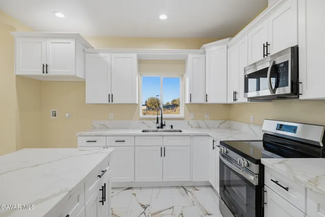 a kitchen with a sink stove and cabinets