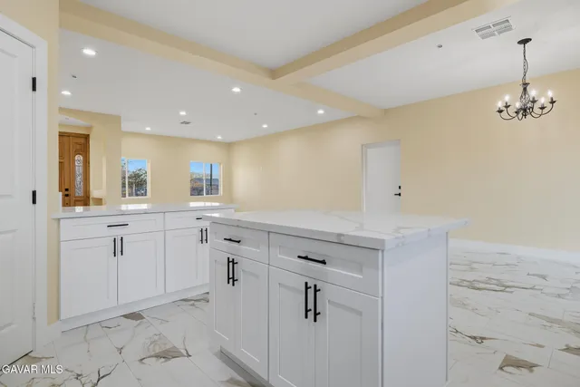 a spacious bathroom with a granite countertop sink a mirror and a vanity
