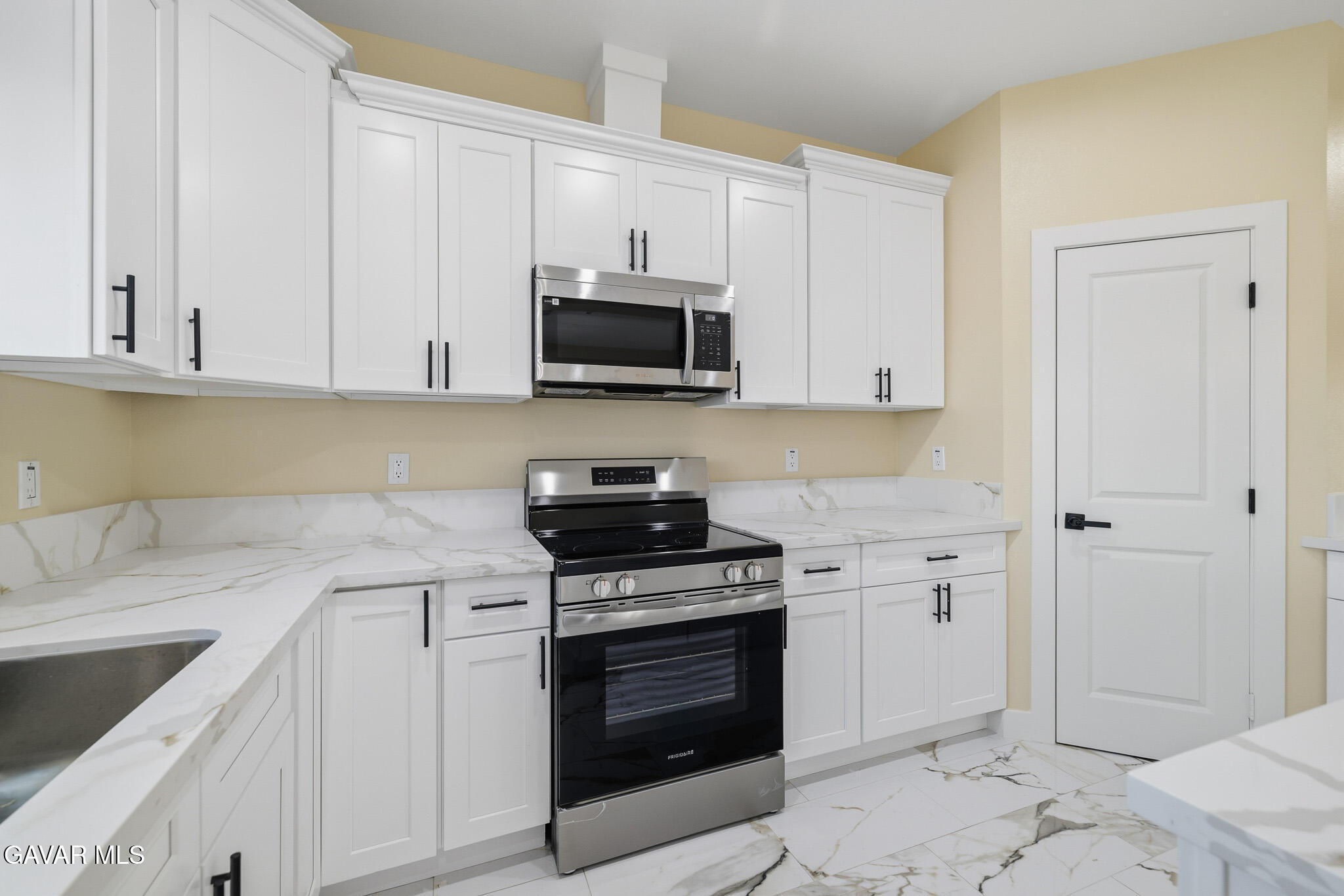 10347 East Ave R 12 Littlerock, CA 93543 - Photo 13 of 32 a kitchen with granite countertop a stove top oven microwave and cabinets