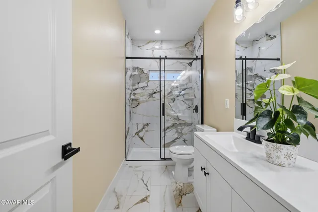 a bathroom with a shower sink and toilet