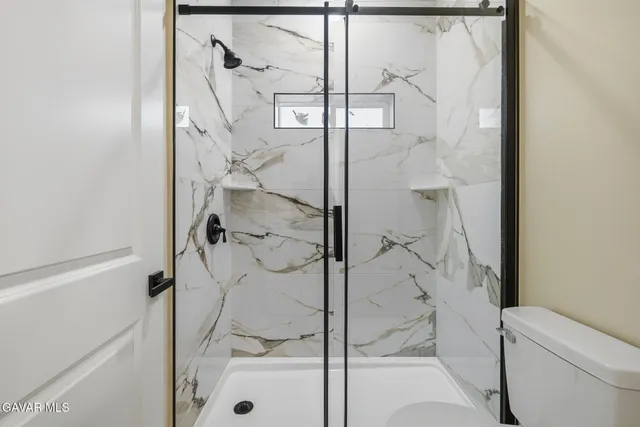 a bathroom with a glass shower door