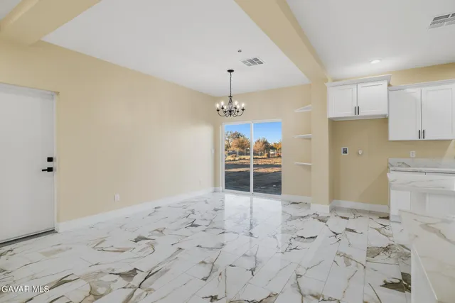 a view of a kitchen with refrigerator and window