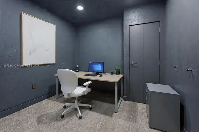 a view of a workspace with furniture