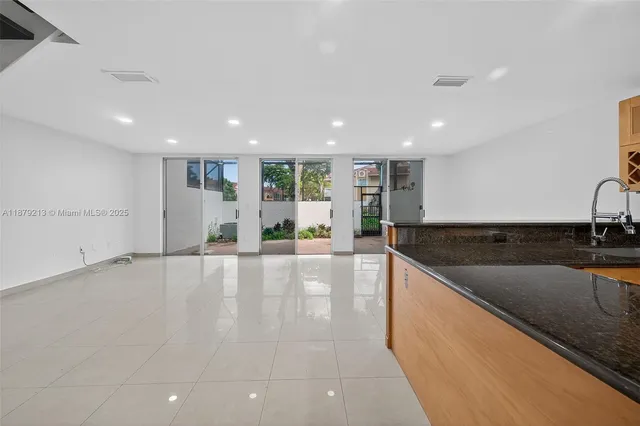 a large kitchen with stainless steel appliances granite countertop a sink and a stove