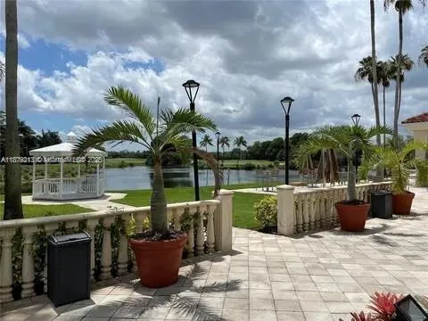a view of a patio with chairs and potted plants