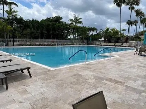 a view of a swimming pool with a yard and a fountain