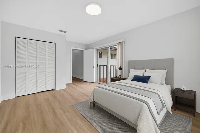 a bedroom with a bed and a closet