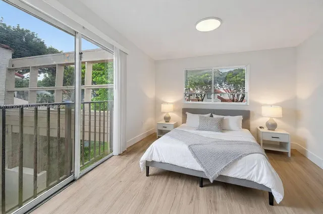 a bedroom with a large bed and a large window