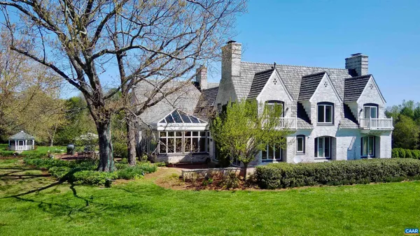 a large kitchen with lots of counter space and chairs