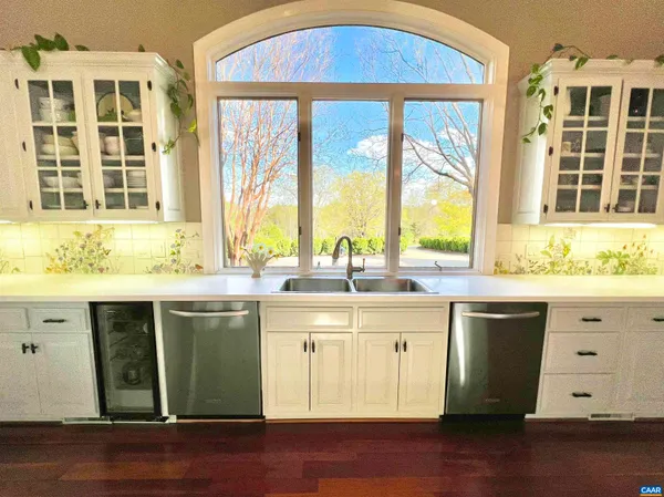 a kitchen that has a lot of cabinets a sink and a stove in it