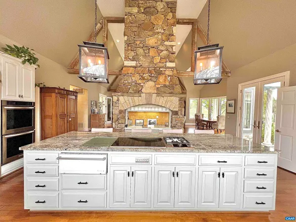 a living room with a fireplace and a wooden floor