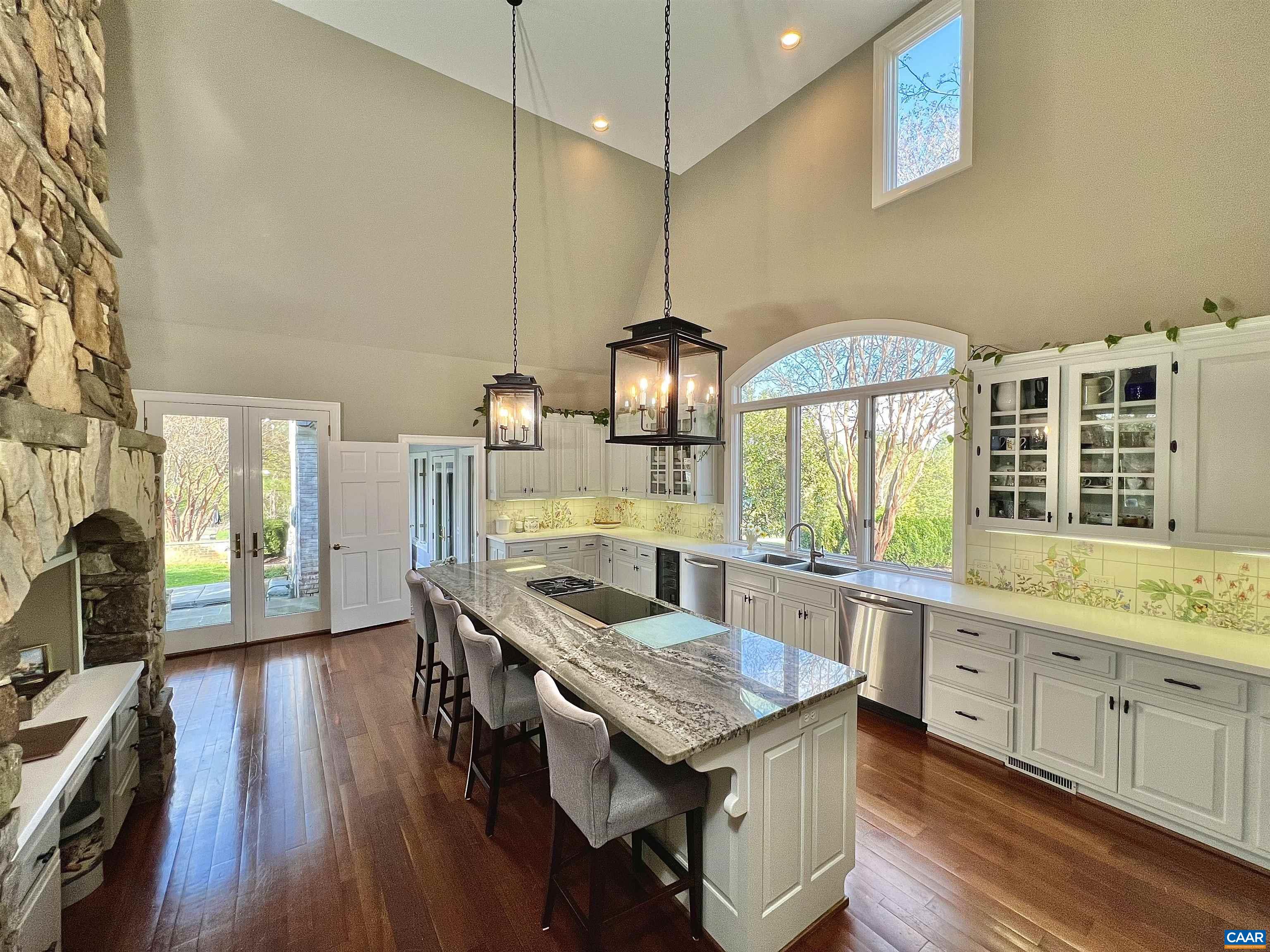 4749 Wesley Chapel Road Free Union, VA 22940 - Photo 18 of 73 a kitchen with granite countertop a stove a sink a dining table and chairs with wooden floor
