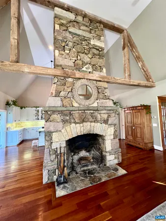 a view of a patio with chairs and a table under an umbrella