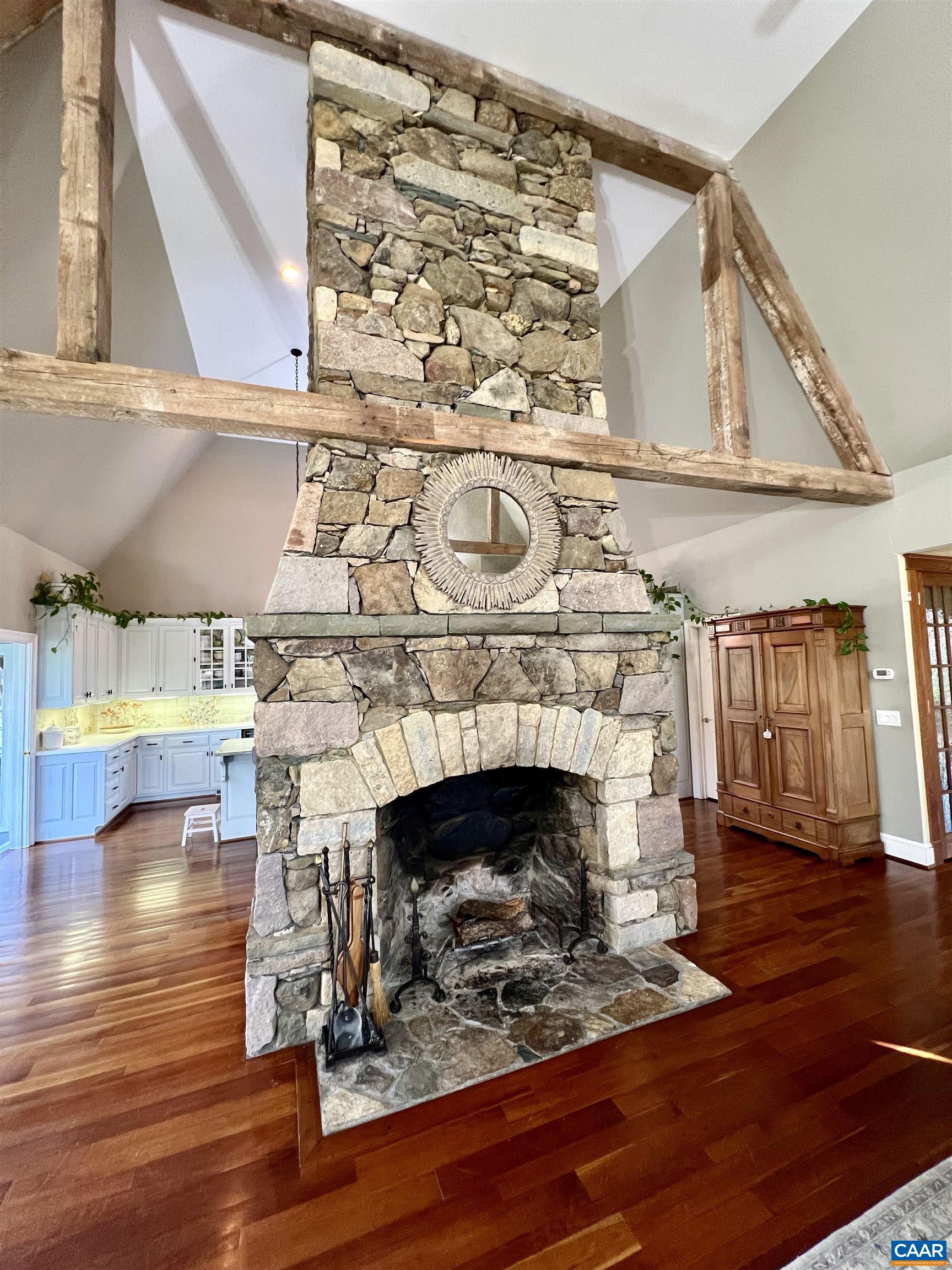 4749 Wesley Chapel Road Free Union, VA 22940 - Photo 21 of 73 a living room with a fireplace and a wooden floor