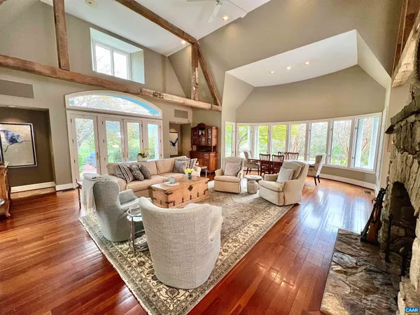a living room with furniture a large window and a flat screen tv