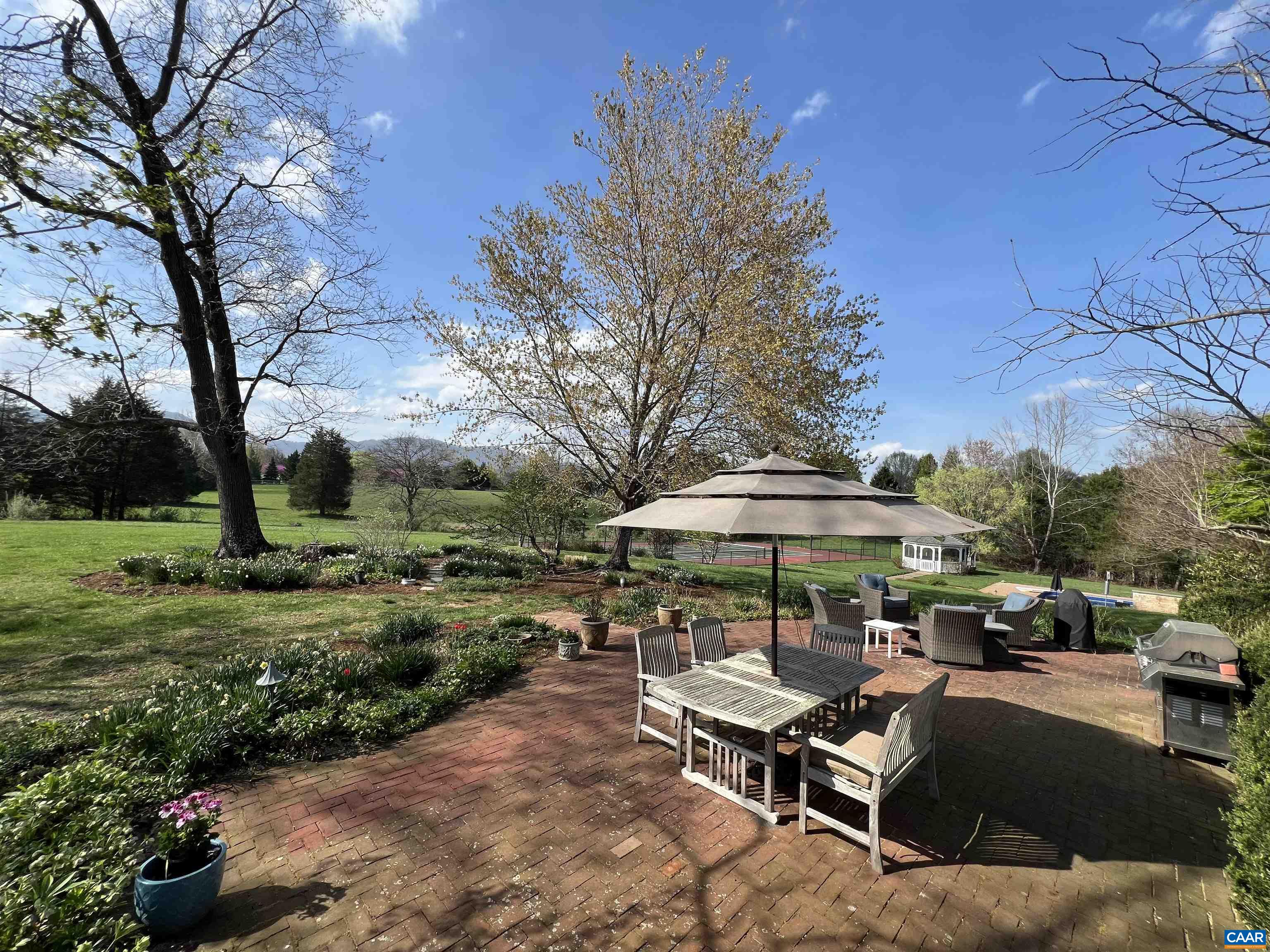 4749 Wesley Chapel Road Free Union, VA 22940 - Photo 28 of 73 a view of a patio with chairs and a table under an umbrella