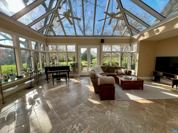 a bathroom with a granite countertop sink a mirror and shower