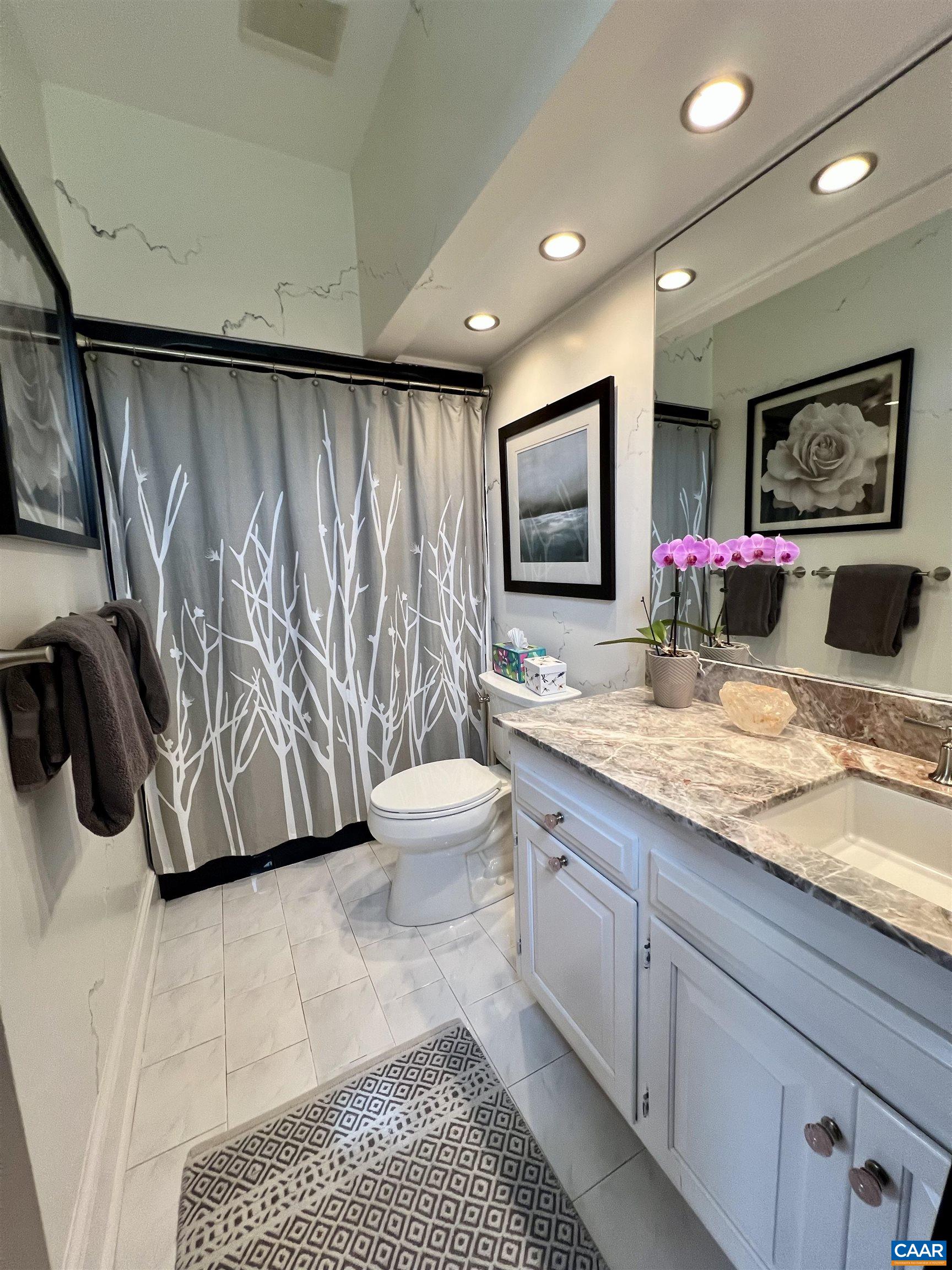 4749 Wesley Chapel Road Free Union, VA 22940 - Photo 40 of 73 a bathroom with a granite countertop sink a mirror and shower