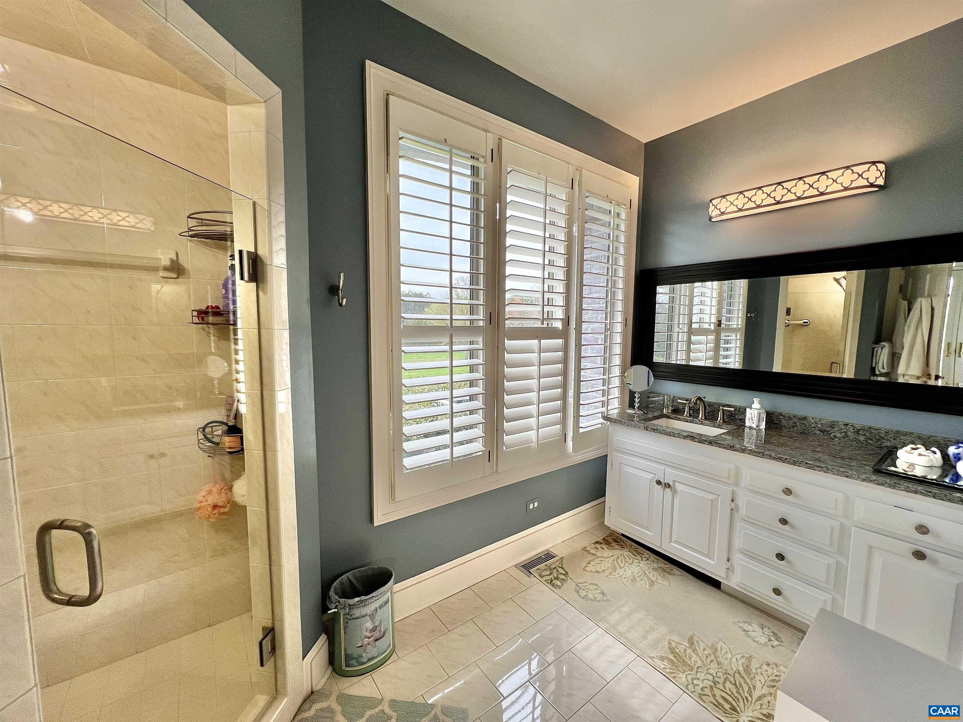 4749 Wesley Chapel Road Free Union, VA 22940 - Photo 43 of 73 a bathroom with a double vanity sink a mirror and a shower
