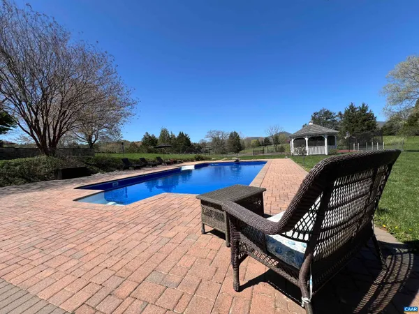 a view of a backyard with a garden and entertaining space