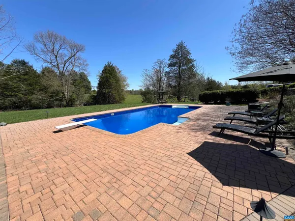 a front view of a house with a yard and tree s