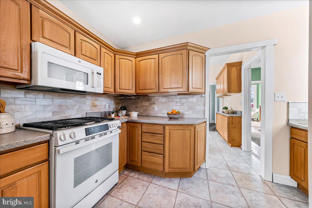 204 Rutledge Avenue Folsom, PA 19033 - Photo 13 of 37 a kitchen with stainless steel appliances granite countertop a stove a sink and a microwave