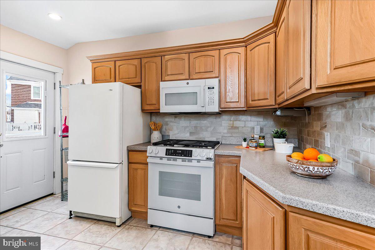 204 Rutledge Avenue Folsom, PA 19033 - Photo 14 of 37 a white refrigerator freezer and a stove top oven