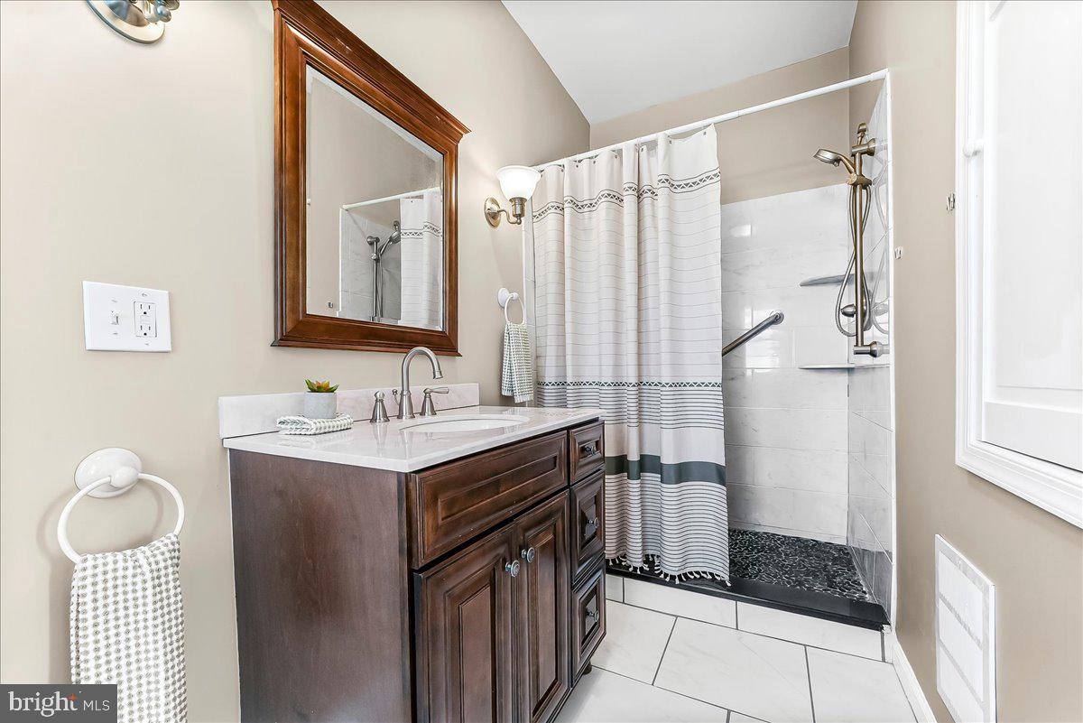 204 Rutledge Avenue Folsom, PA 19033 - Photo 24 of 37 a bathroom with a sink a toilet and shower