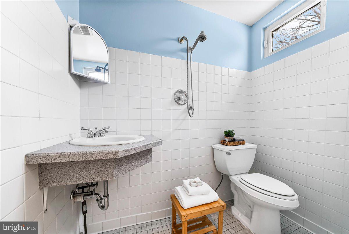 204 Rutledge Avenue Folsom, PA 19033 - Photo 30 of 37 a bathroom with a toilet sink and mirror