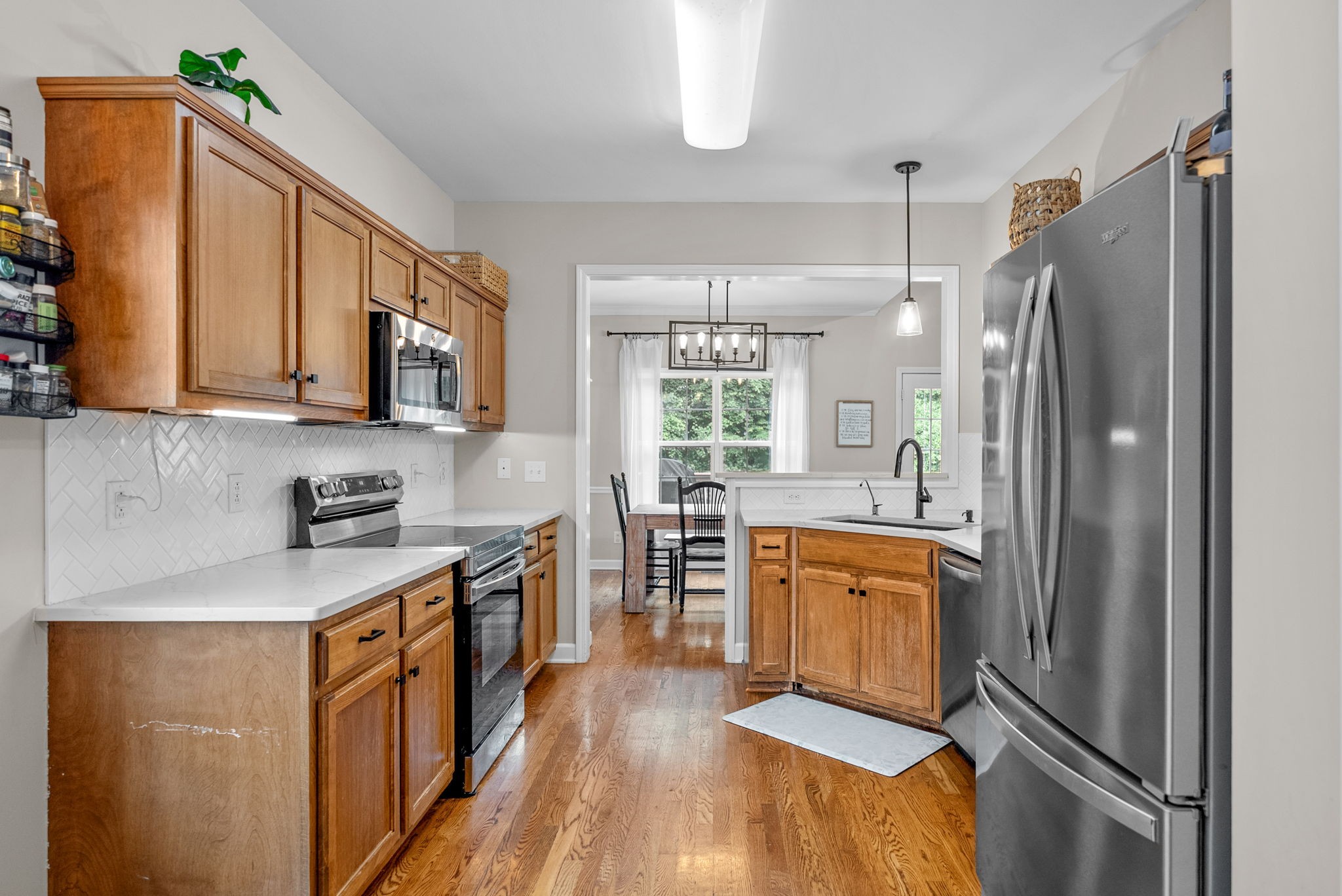1161 Cynthia Lane Spring Hill, TN 37174 - Photo 11 of 42 a kitchen with stainless steel appliances granite countertop a refrigerator a stove a sink and a microwave