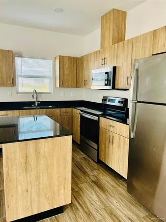 a kitchen with stainless steel appliances a refrigerator stove and sink