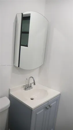a bathroom with a sink and mirror