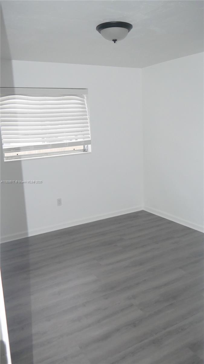 1930 Northwest 55th Street Miami, FL 33142 - Photo 16 of 30 a view of a small space with wooden floor and a window