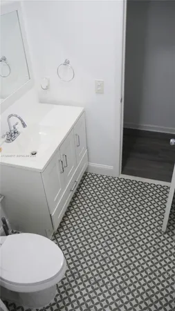 a bathroom with a sink a toilet and a mirror
