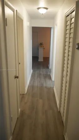 a view of a bathroom from a hallway