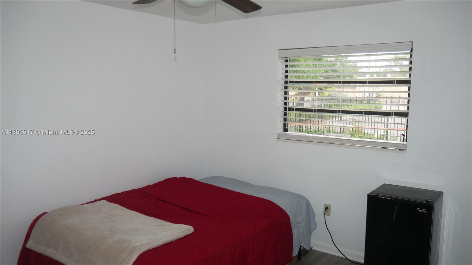 1930 Northwest 55th Street Miami, FL 33142 - Photo 22 of 30 a bedroom with a bed and a window