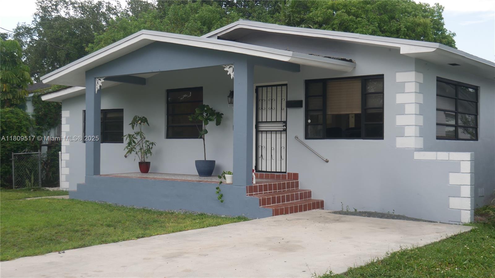1930 Northwest 55th Street Miami, FL 33142 - Photo 30 of 30 a front view of a house with a yard