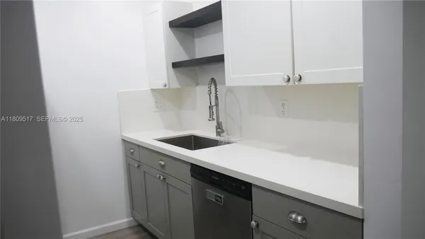 a kitchen with a sink and cabinets