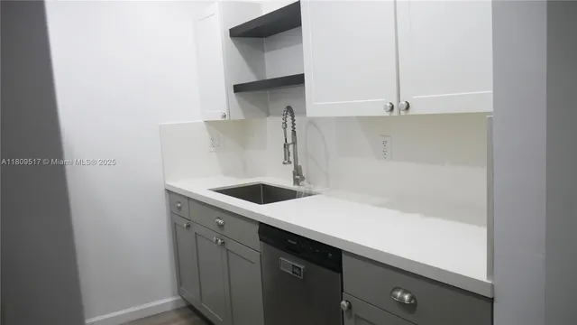 a kitchen with a sink and cabinets