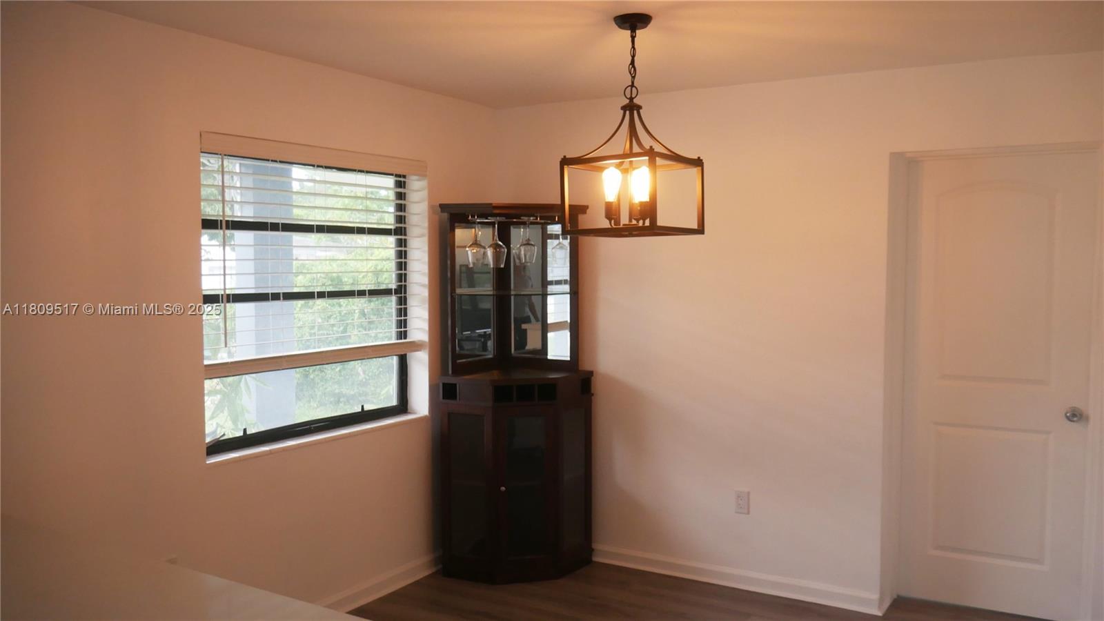 1930 Northwest 55th Street Miami, FL 33142 - Photo 6 of 30 a view of empty room with window and wooden floor