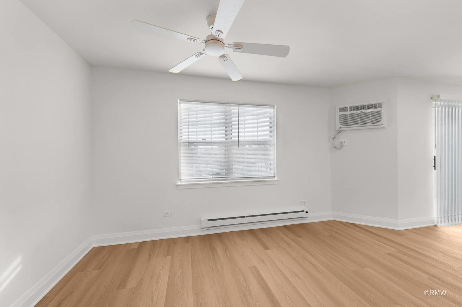 224 South Rush Street, Unit 3A Itasca, IL 60143 - Photo 7 of 13 an empty room with a window and a ceiling fan