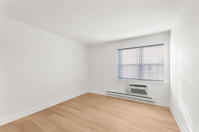 a view of a room with wooden floor and cabinet