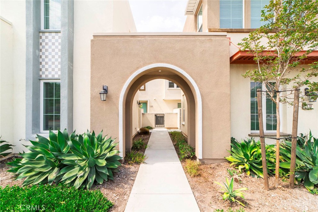 a view of a brick house with potted plants