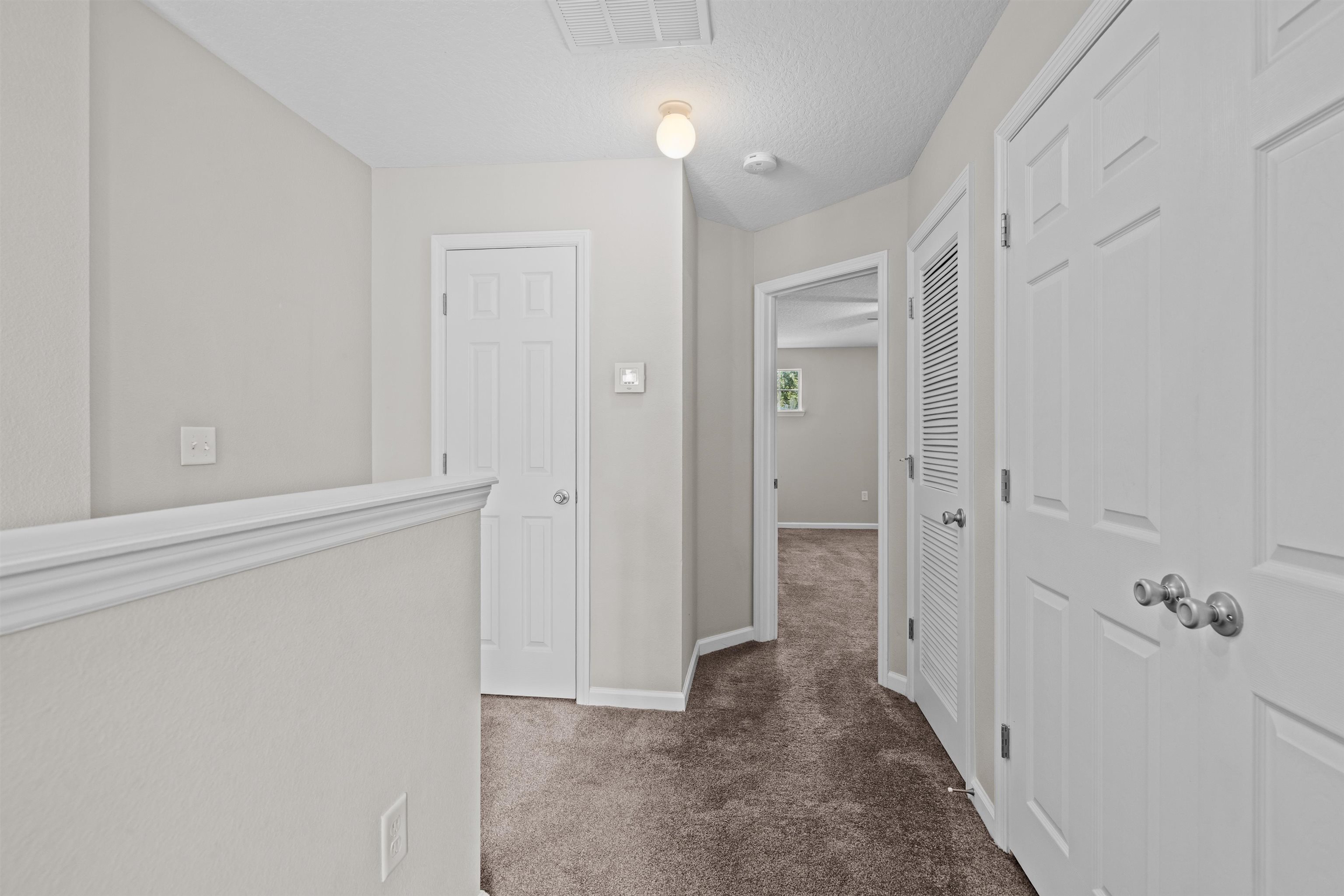 24 Islander Court St. Augustine, FL 32080 - Photo 13 of 35 a view of a hallway with wooden floor and staircase
