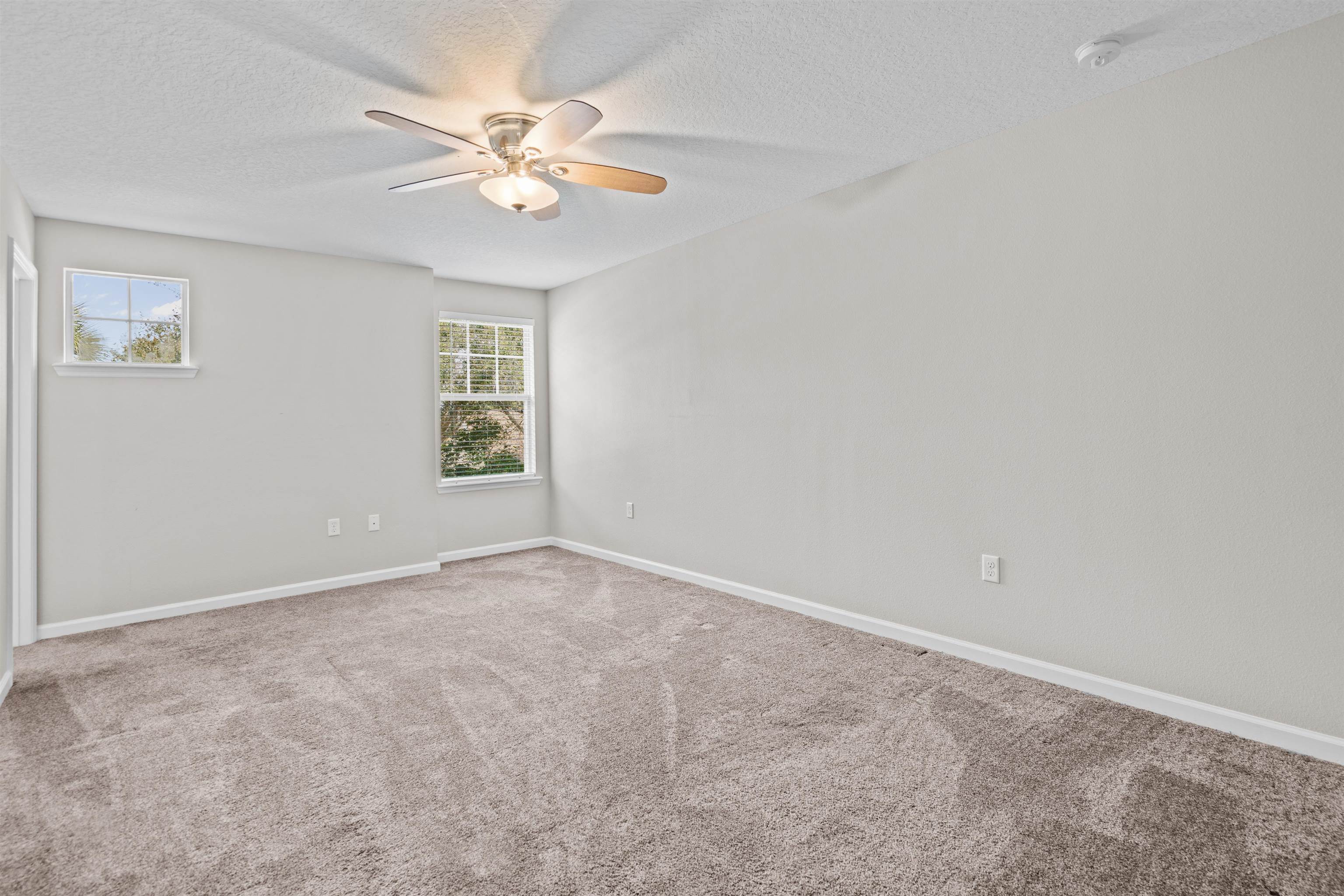 24 Islander Court St. Augustine, FL 32080 - Photo 18 of 35 an empty room with a window and a ceiling fan