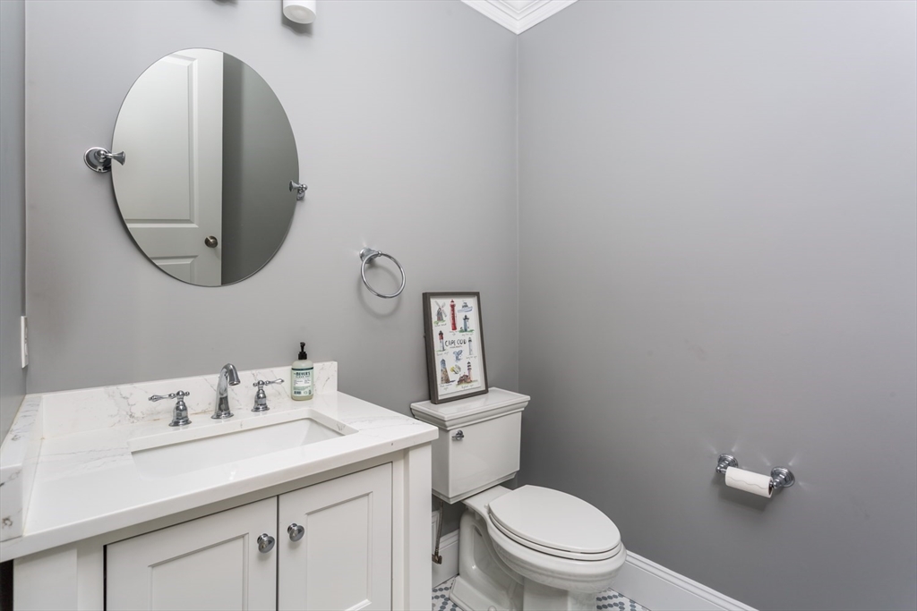 216 Oak Street Westwood, MA 02090 - Photo 11 of 37 a bathroom with a toilet sink vanity and mirror