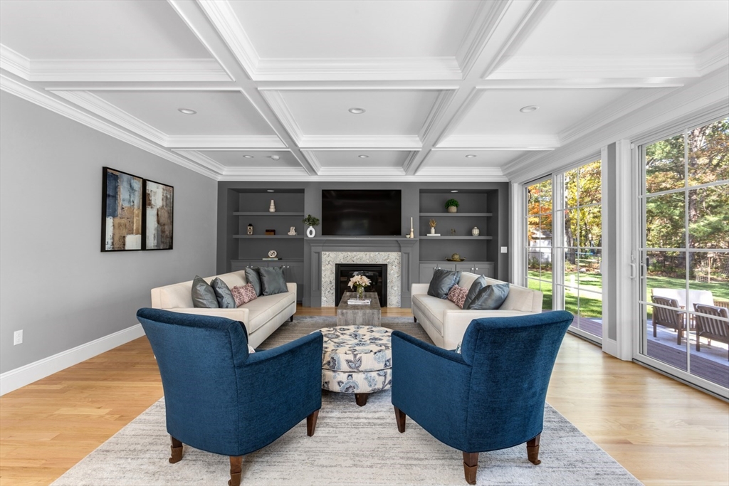 216 Oak Street Westwood, MA 02090 - Photo 12 of 37 a living room with furniture a large window and a fireplace