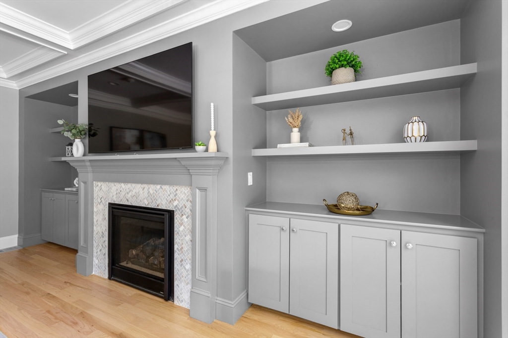 216 Oak Street Westwood, MA 02090 - Photo 13 of 37 a hallway with a fireplace and wooden floor